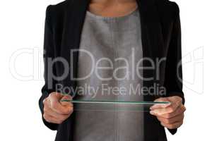 Mid section of businesswoman holding glass interface