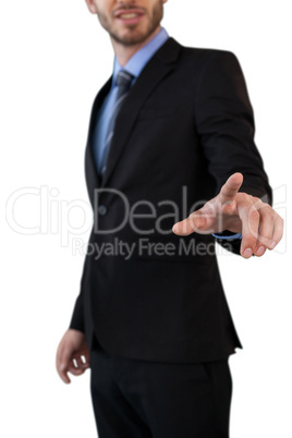 Mid section of businessman in suit touching index finger on invisible interface