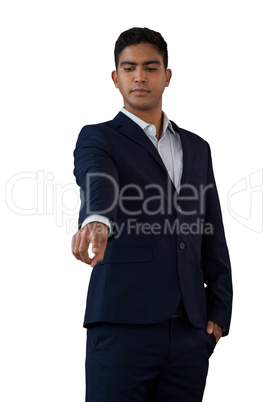 Businessman with hands in pockets touching invisible interface