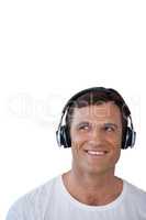 Happy mature man wearing headphones looking away