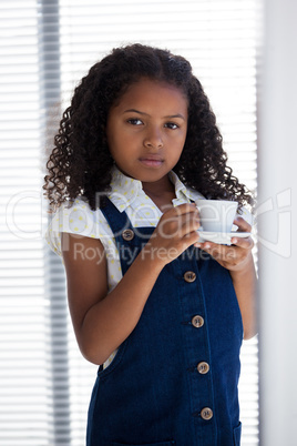 Portrait of businesswoman holding coffee cup