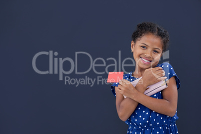 Portrait of smiling girl holding credit card while holding purse