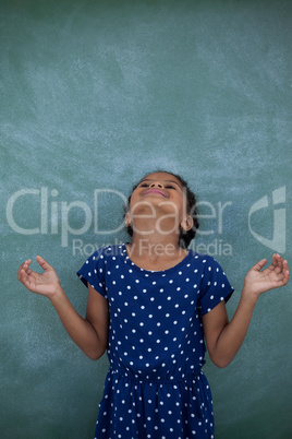 Happy girl with head back by wall