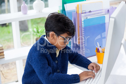 High angle view of businessman using desktop computer at desk