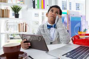 Businessman looking up while talking on mobile phone