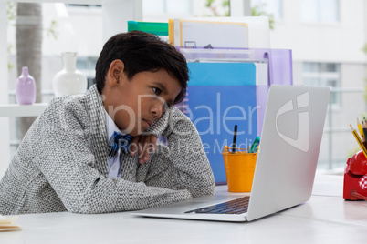 Bored businessman looking at laptop