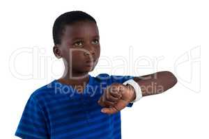 Thoughtful boy with smart watch