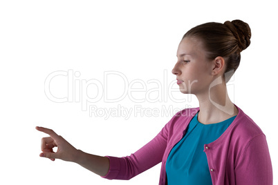 Teenage girl pressing an invisible virtual screen