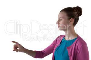 Teenage girl pressing an invisible virtual screen