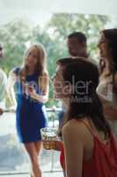 Woman having cocktail drink with friends