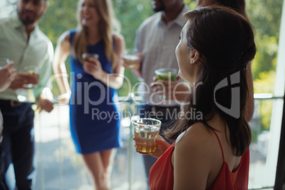 Woman having cocktail drink with friends