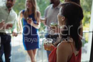 Woman having cocktail drink with friends