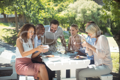 Group of friends looking picture on mobile phone