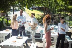 Friends interacting while having glass of wine in restaurant