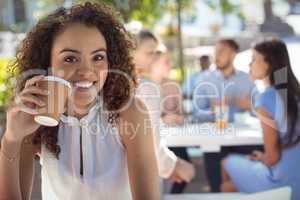 Smiling beautiful woman having coffee in restaurant