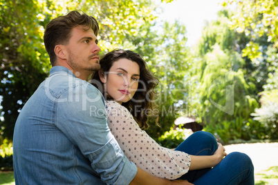 Couple embracing each other in garden on a sunny day