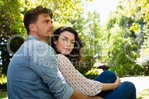 Couple embracing each other in garden on a sunny day