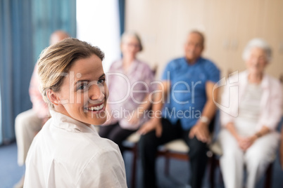 Portrait of smiling female doctor with senior people