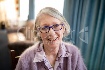 Portrait of cheerful senior woman wearing eyeglasses