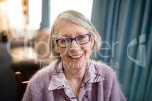 Portrait of cheerful senior woman wearing eyeglasses