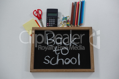 Back to school text on slate with various supplies