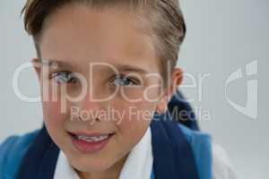 Smiling schoolboy looking at camera