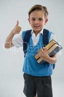 Portrait of school boy showing thumbs up