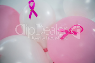 Close-up of pink Breast Cancer Awareness ribbons on balloons