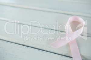 Close-up of pink Breast Cancer Awareness ribbon on table