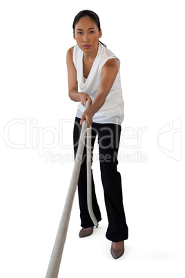 Portrait of young woman pulling rope