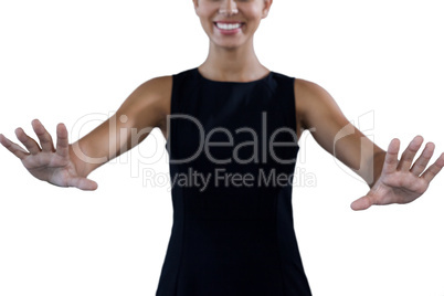 Mid section of happy young businesswoman using invisible interface
