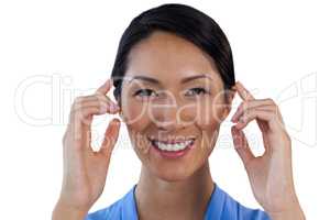 Close up portrait of smiling businesswoman adjusting invisible eyeglasses