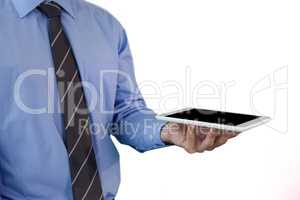 Mid section of businessman wearing necktie holding tablet