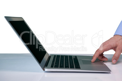 Cropped hand on businessman touching touch pad on laptop