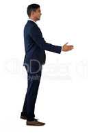 Side view of businessman extending arms for handshake
