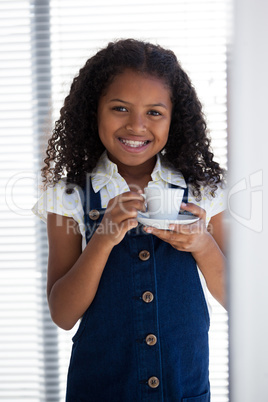 Portrait of smiling businesswoman holding coffee cup