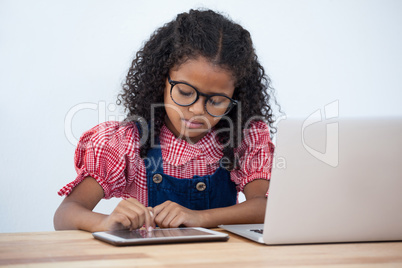 Businesswoman using tablet while sitting at desk