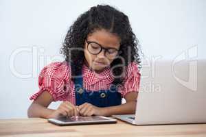 Businesswoman using tablet while sitting at desk