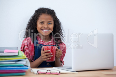 Portrait of smiling businesswoman with coffee cup