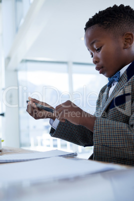 Businessman checking pen while making report