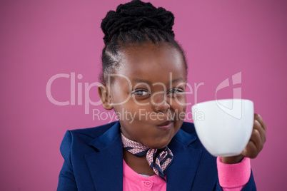 Businesswoman making face while having coffee