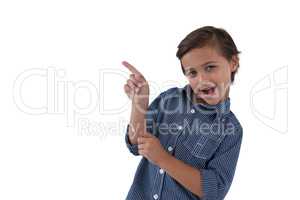 Cute boy pointing finger against white background