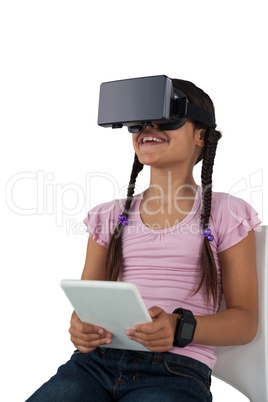 Girl using virtual reality headset and digital tablet