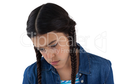 Sad girl looking down against white background