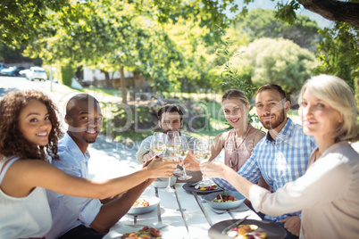 Group of friends toasting glasses of wine in a restaurant