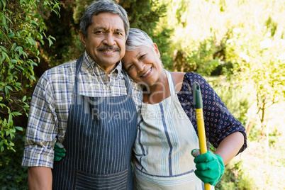 Senior couple standing in garden on a sunny day