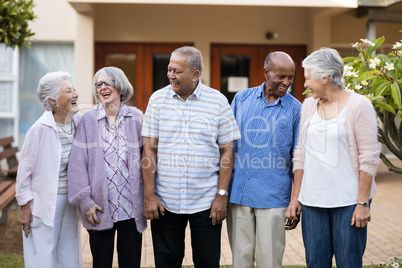 Cheerful senior men and women at nursing home