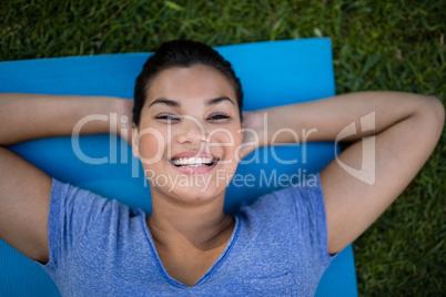 High angle portrait of smiling trainer on mat
