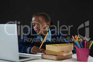 Schoolgirl looking at laptop