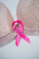 Close-up of spotted pink Breast Cancer Awareness ribbon on bra